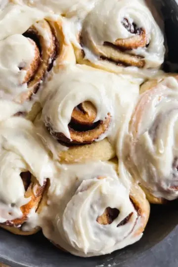 No knead sourdough cinnamon rolls with cream cheese frosting.