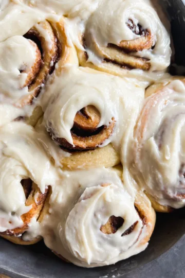 No knead sourdough cinnamon rolls with cream cheese frosting.