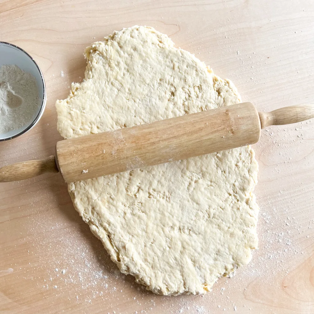Biscuit dough that has bee rolled to 1 inch thickness.