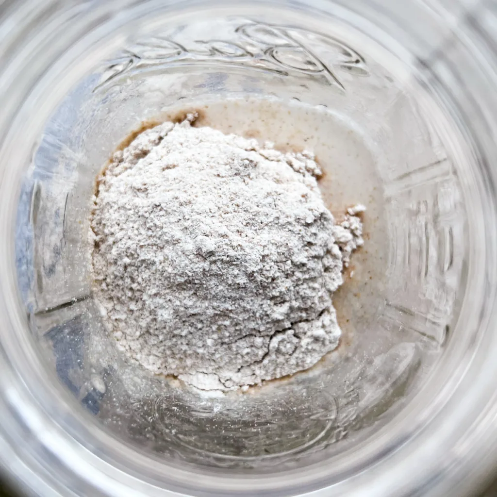 mixing flour and water together to make a sourdough starter