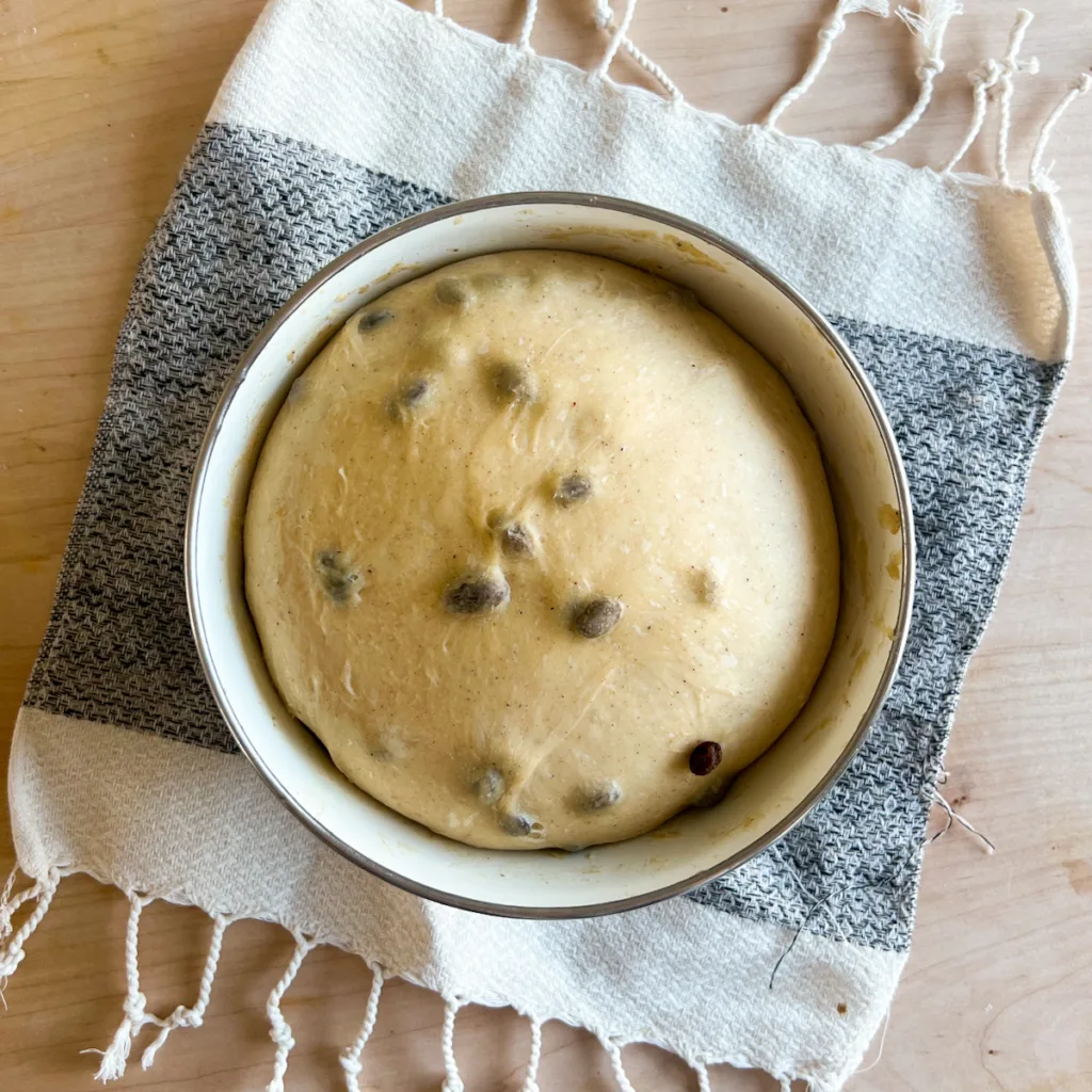 hot cross bun dough at the end of bulk ferment that has doubled in size.