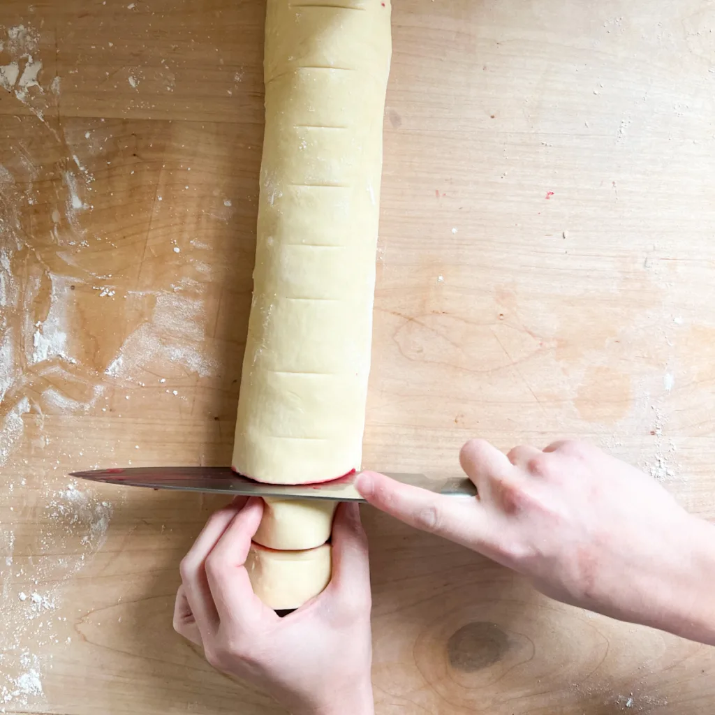 cutting the sourdough raspberry lemon rolls
