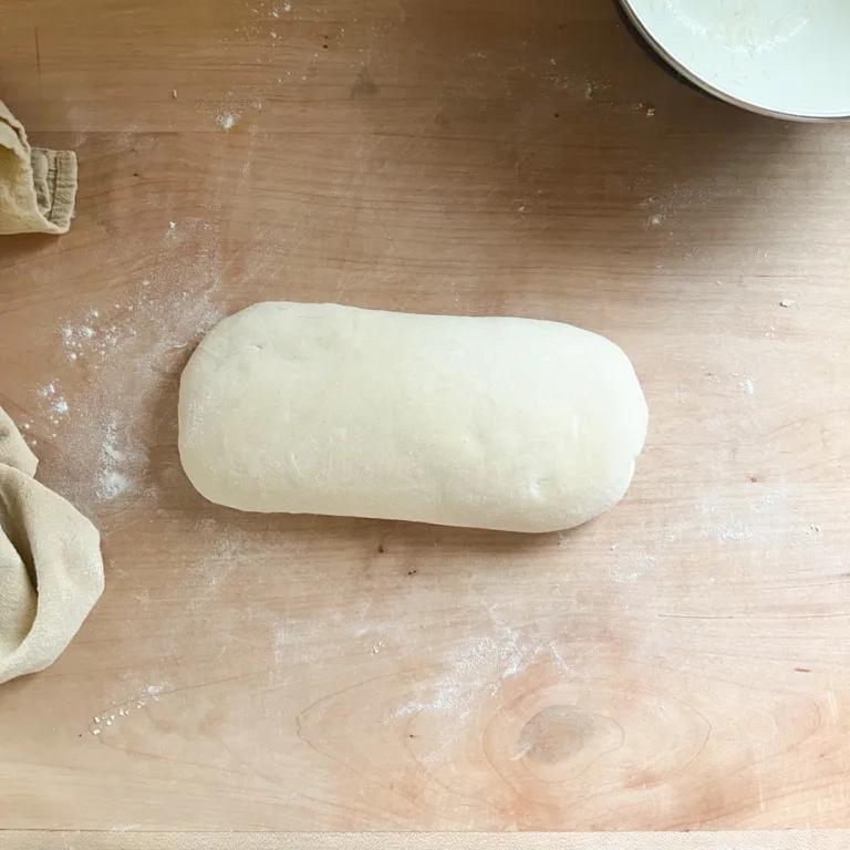 garlic knot dough that has been rolled into a log.