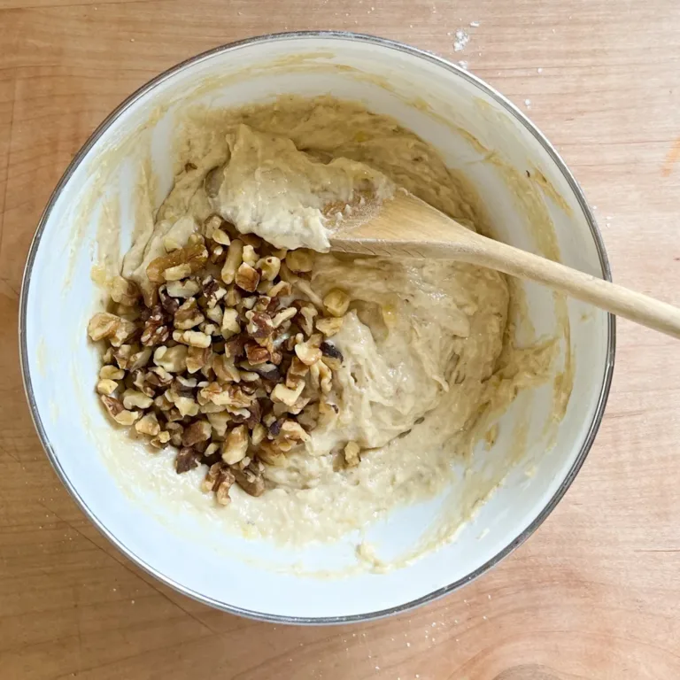 mixing walnuts into banana muffin batter