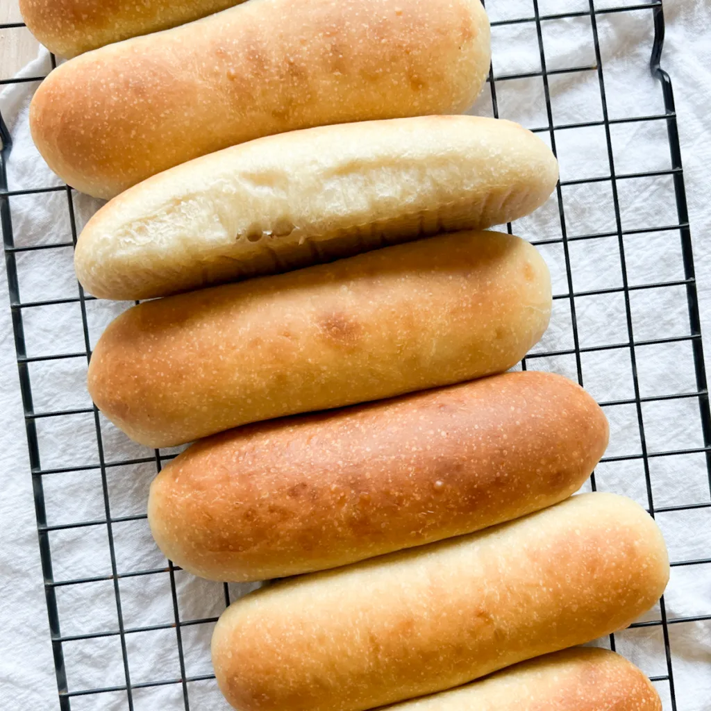 sourdough hot dog buns on a cooling rack