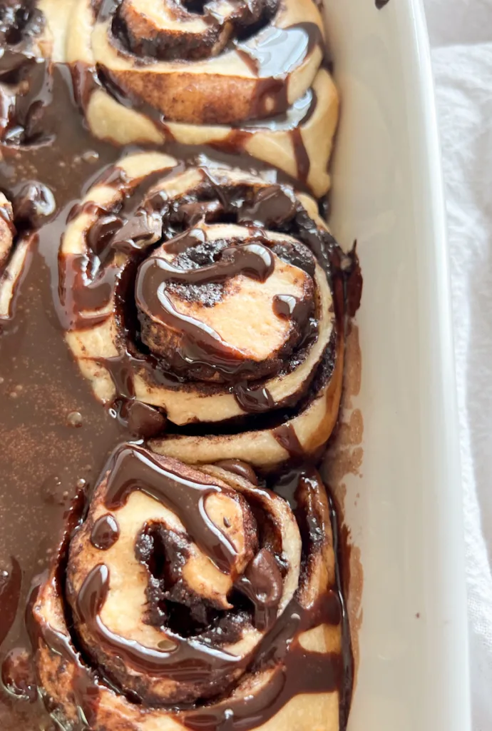 sourdough chocolate rolls with chocolate frosting drizzled on top