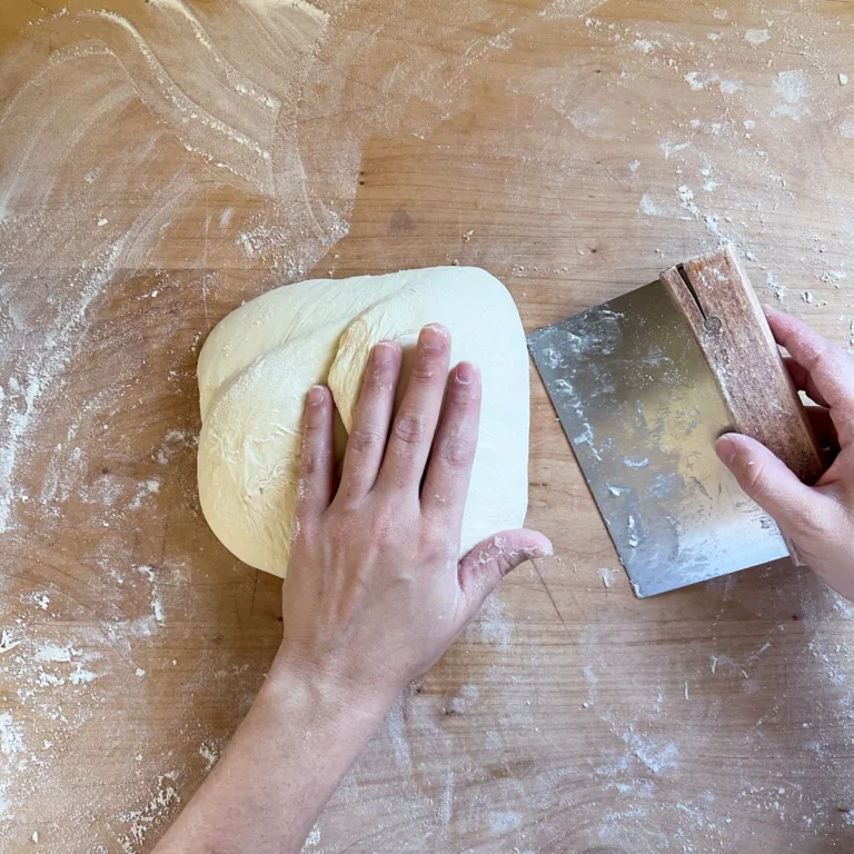 Folding the right portion of dough into the center.