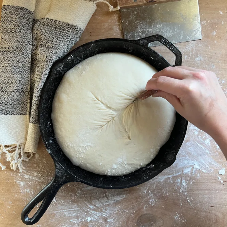 Scoring the sourdough country loaf with a razor blade.