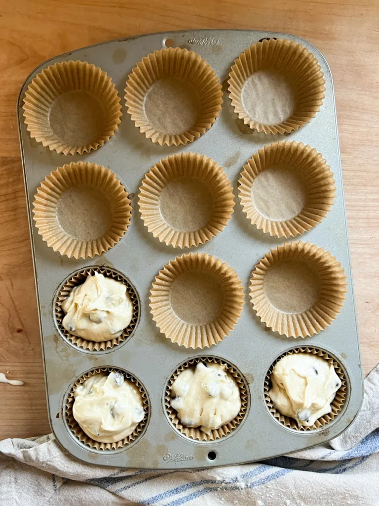 A standard 12-muffin pan with liners in it.