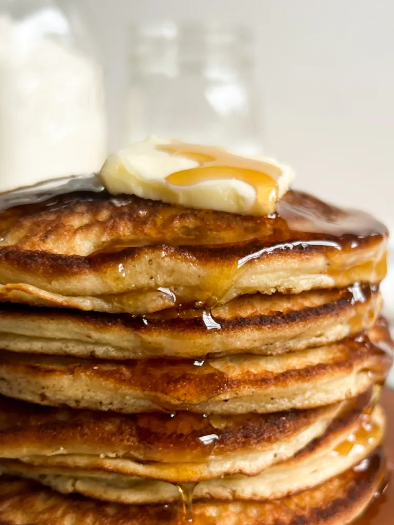 A large stack of sweet cream pancakes.