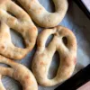 Sourdough fougasse that has been shaped like ghosts.