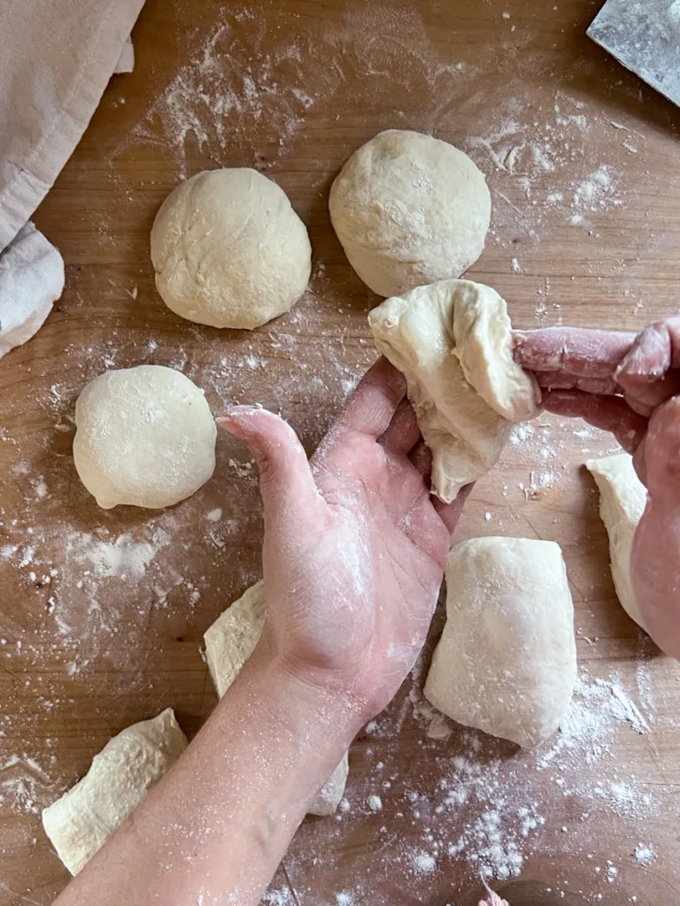 Shaping the dough portions into balls.