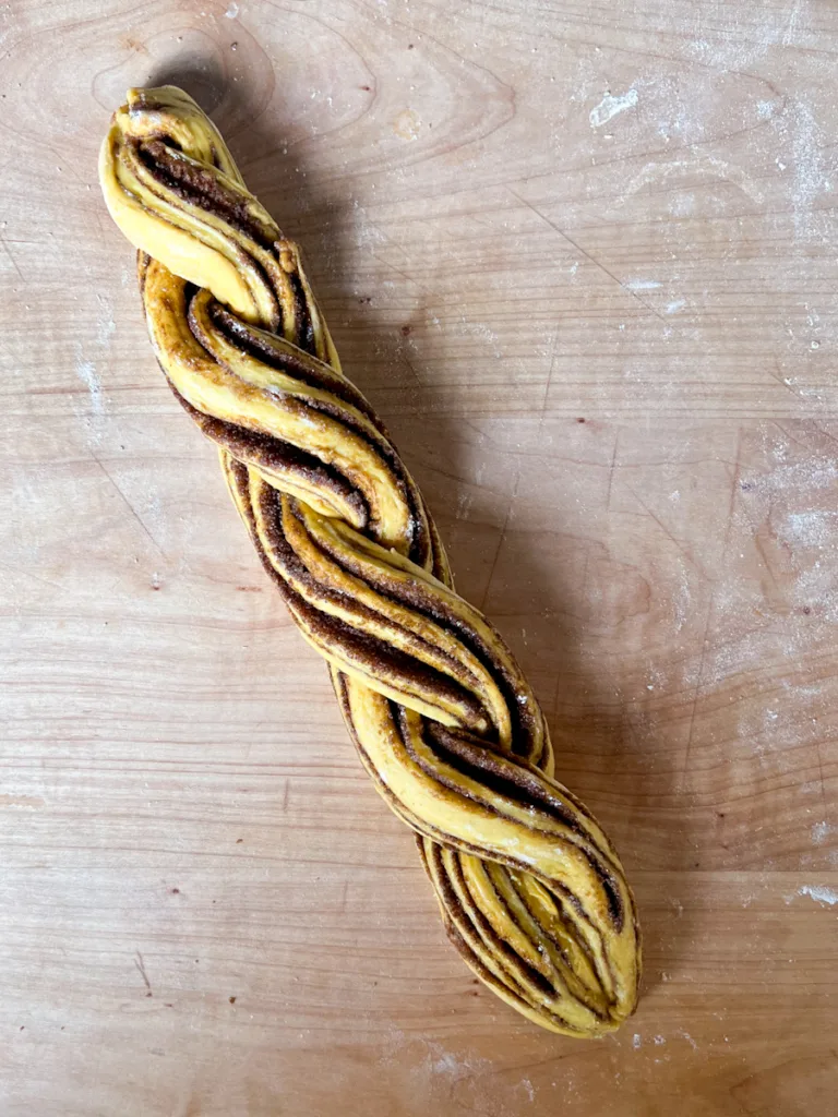 Two strips of dough after having been braided together.