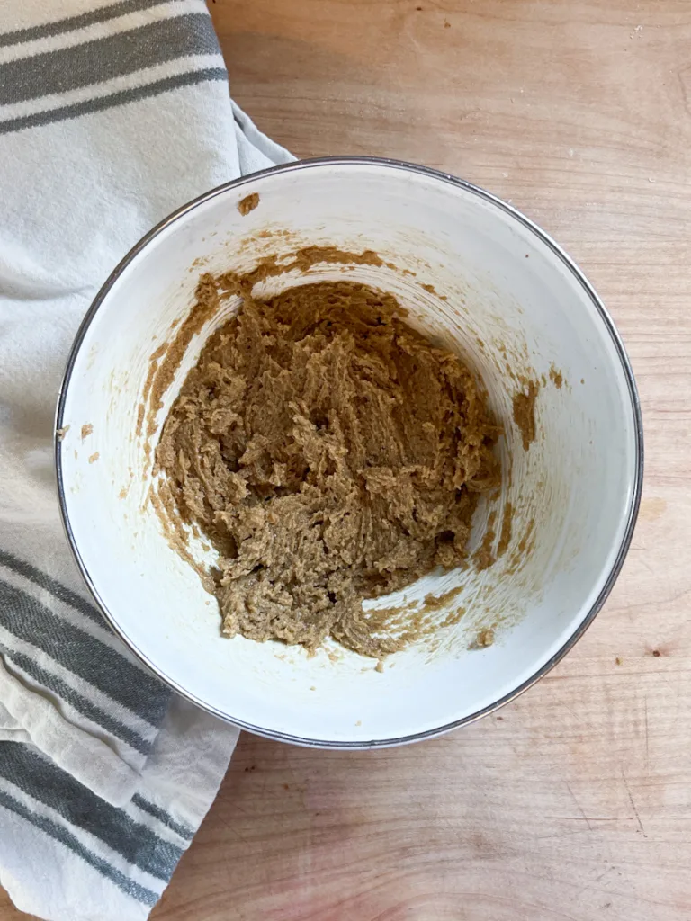 The butter and brown sugar in a bowl after being mixed.