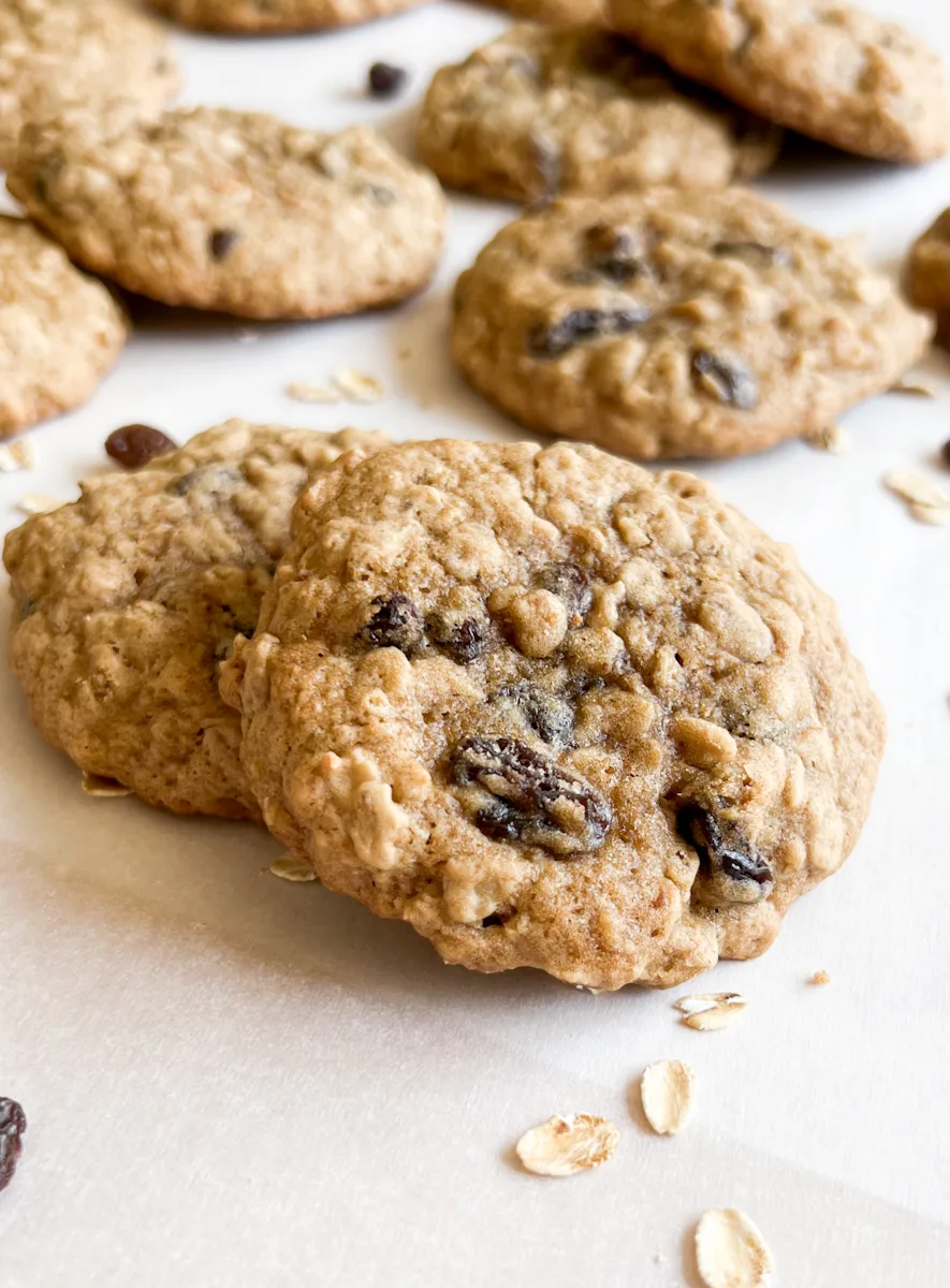 Sourdough oatmeal raisin cookies on parchment paper.