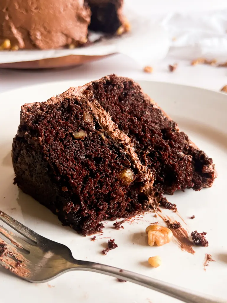 A slice of chocolate walnut cake on a plate.