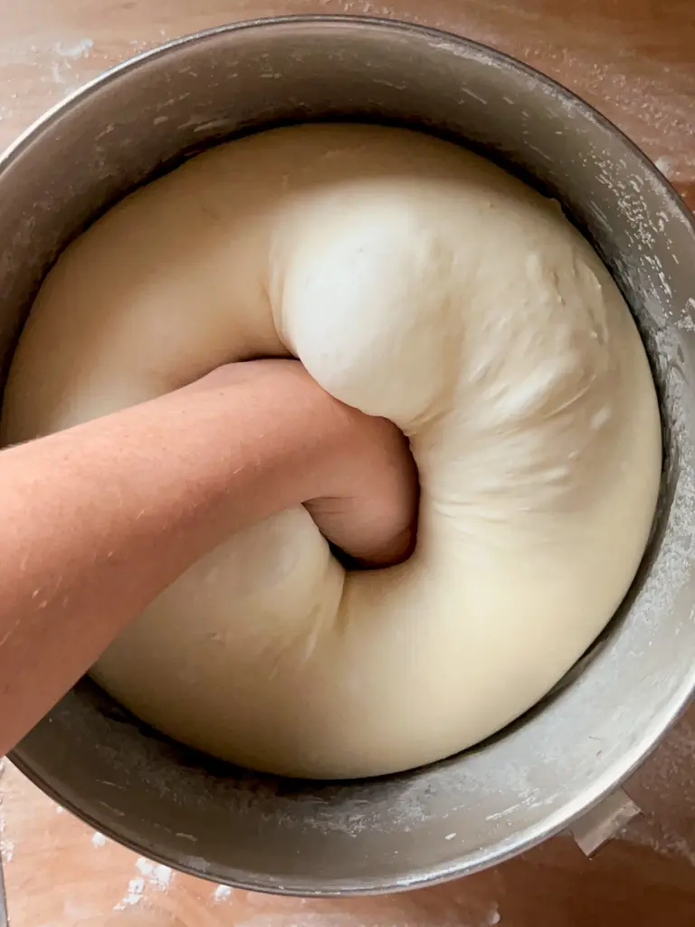 The dough balls being punched down.