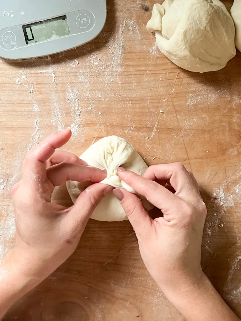 Pinching the dough together to form a ball.
