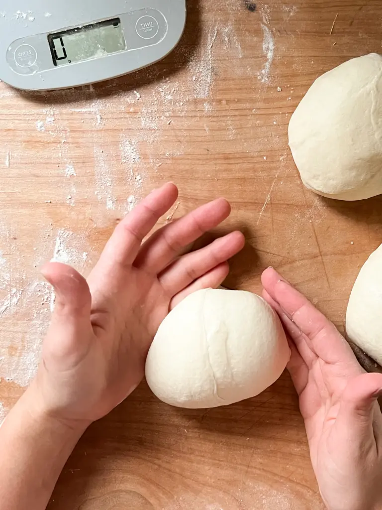 Shaping the dough to form a prefect round ball.