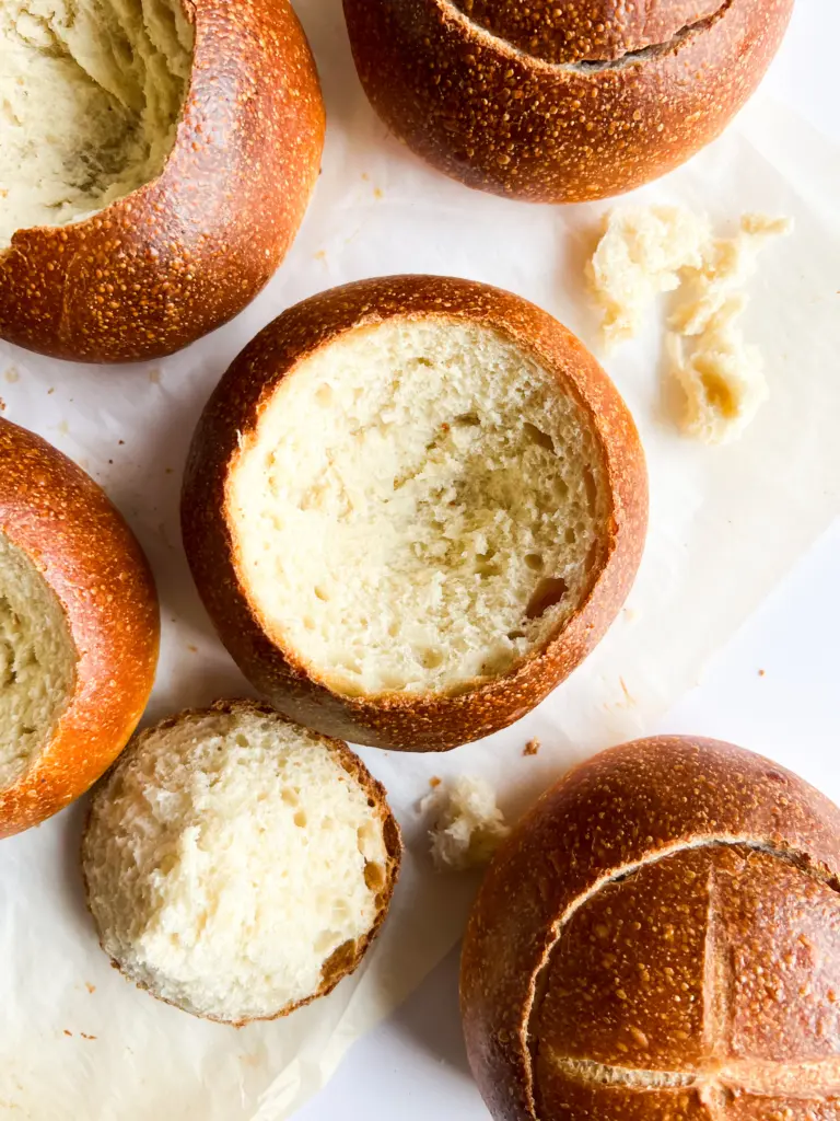 A few sourdough bread bowls sitting next to eachother.