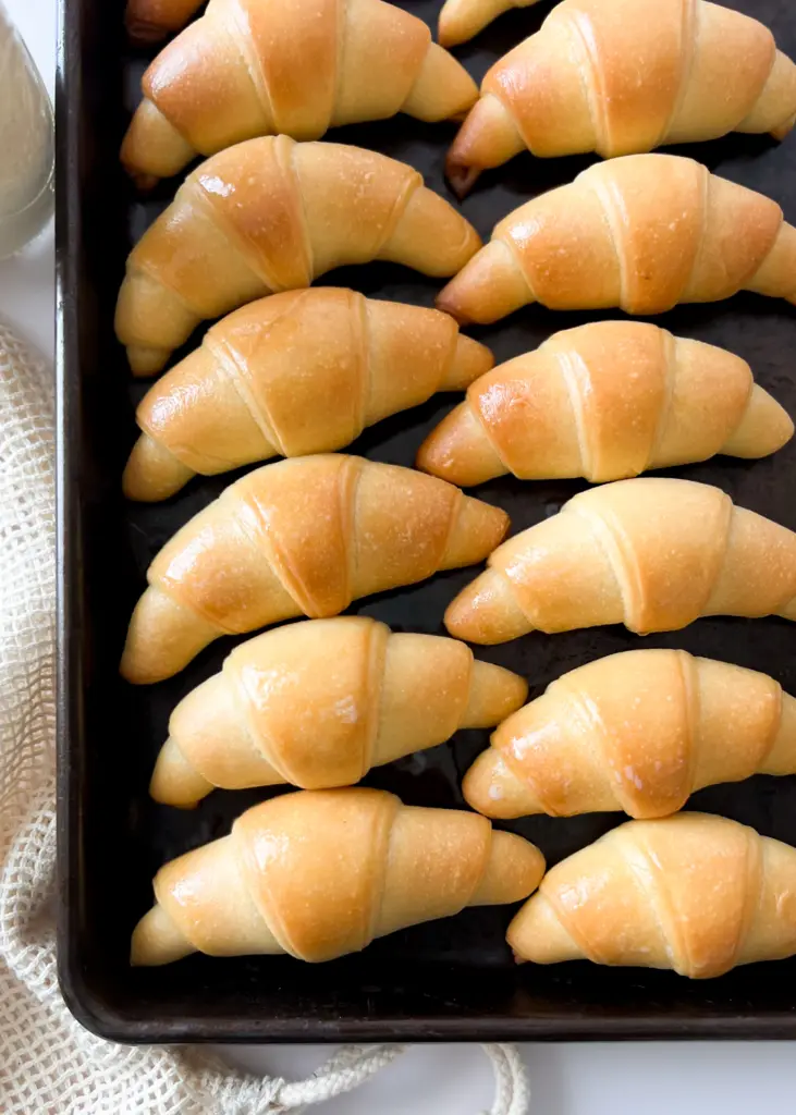 A baking sheet lined with sourdough crescent rolls.