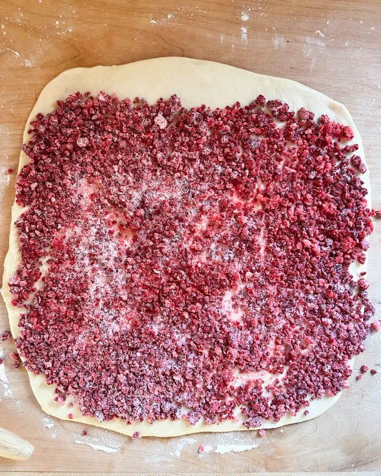 frozen raspberry filling spread across the dough.
