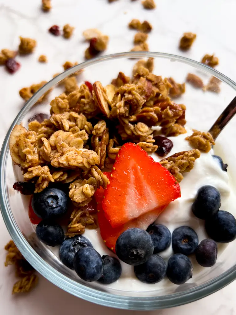 A bowl filled with yogurt, fresh fruit, and sourdough granola.