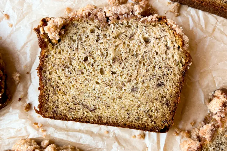 A slice of banana bread with streusel topping.