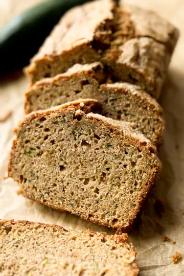 A loaf of sourdough discard zucchini bread cut into slices.