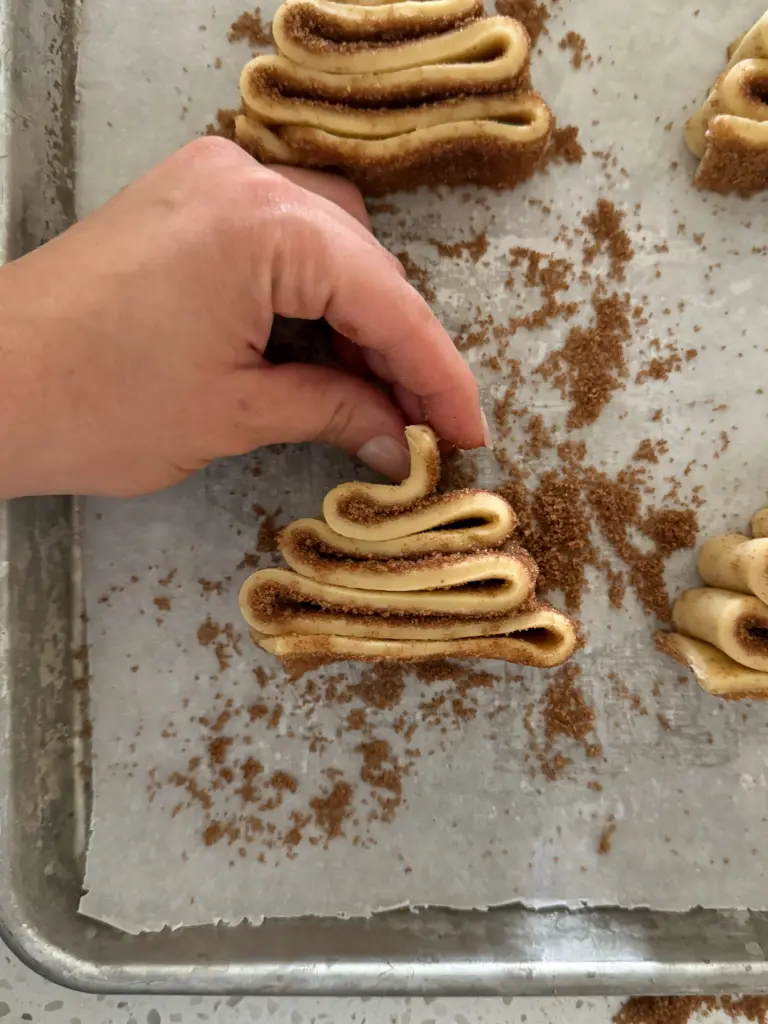 Making a Christmas tree shaped cinnamon roll.