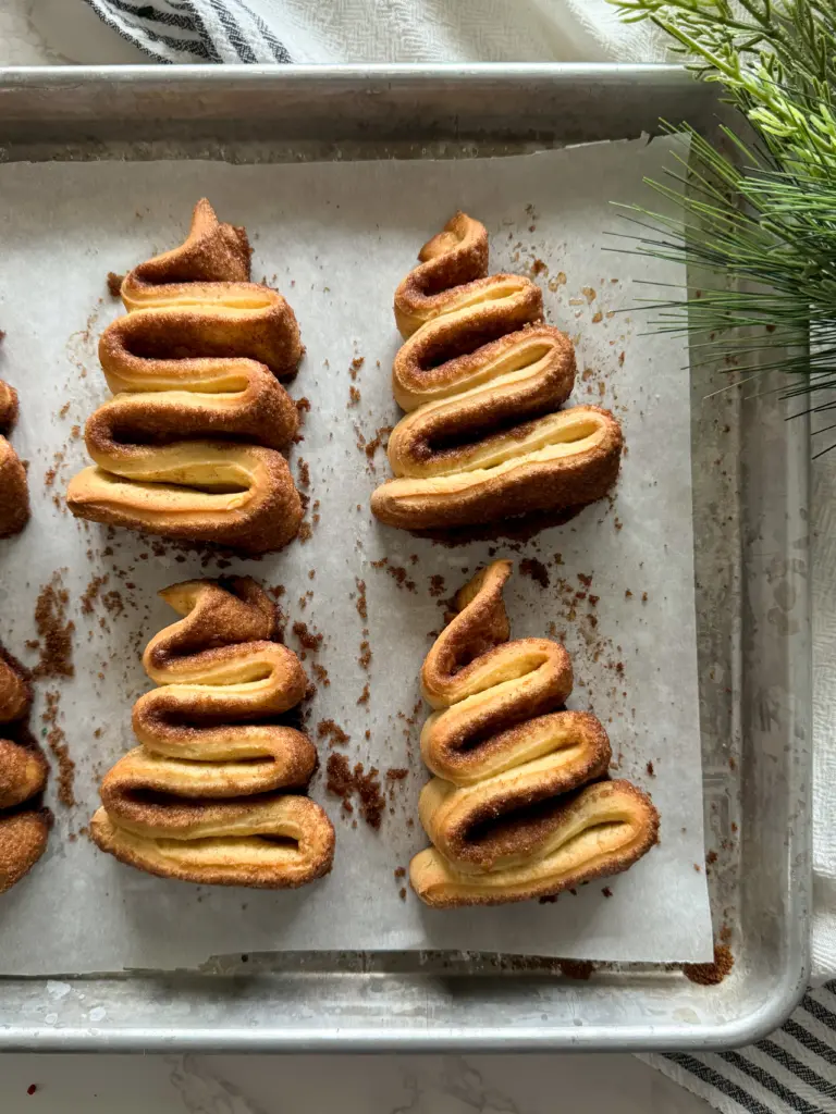 A tray of christmas tree cinnamon rolls before they have been frosted.