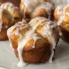 A monkey bread muffin with simple icing drizzled on top.
