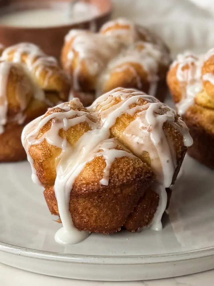 A monkey bread muffin with simple icing drizzled on top.