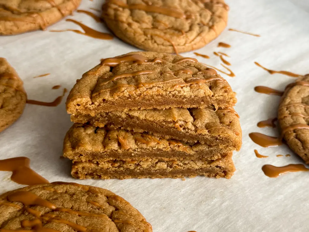 A stack of biscoff cookie butter cookies, cut open to reveal the extra soft and chewy center.
